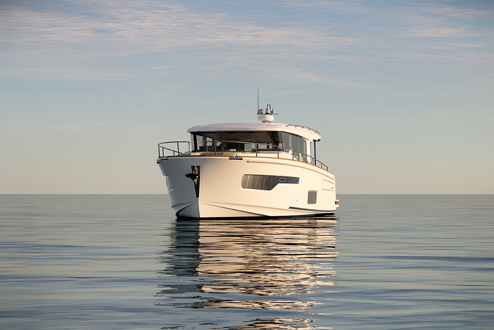 Nimbus 495 Coupé cruising head-on in calm seas, showing enclosed wheelhouse design.