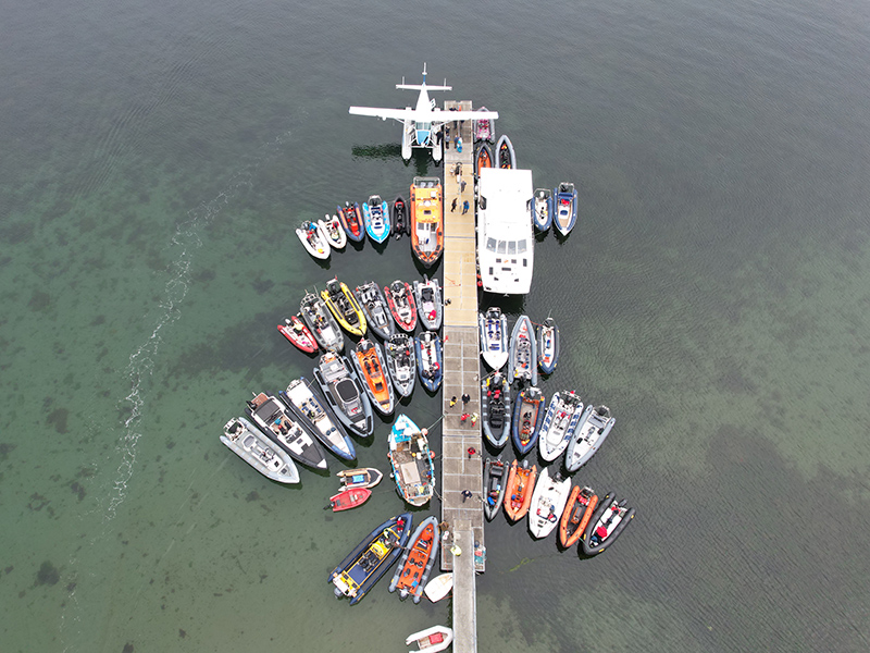 Aerial view of dozens of RIBs rafted around a pontoon during RIB Rendezvous.
