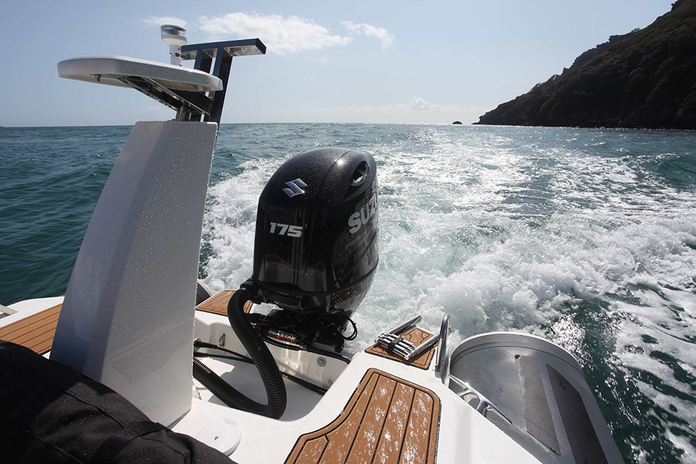 Suzuki 175hp outboard powering a RIB underway, showing repowered transom performance in coastal conditions.