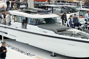 Axopar 38 on display stand at boot Dusseldord boat show with people walking around the neighbouring stands