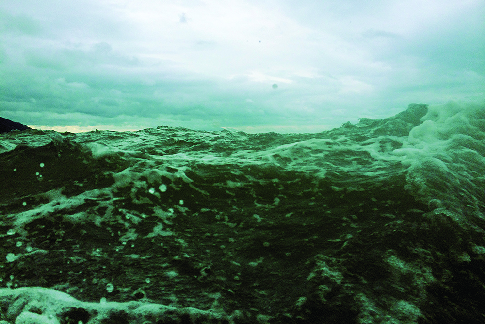 Heavy Atlantic swell and breaking waves under a brooding sky in rough winter sea conditions.