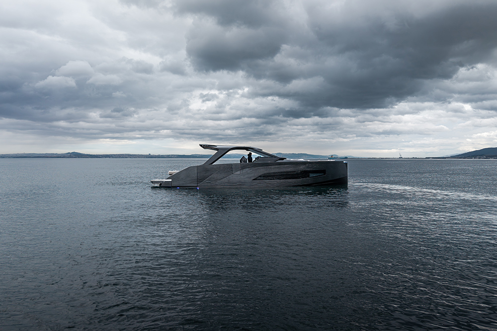 Manari 52 motor yacht underway on calm water beneath dramatic overcast skies, showcasing its low-profile modern design.
