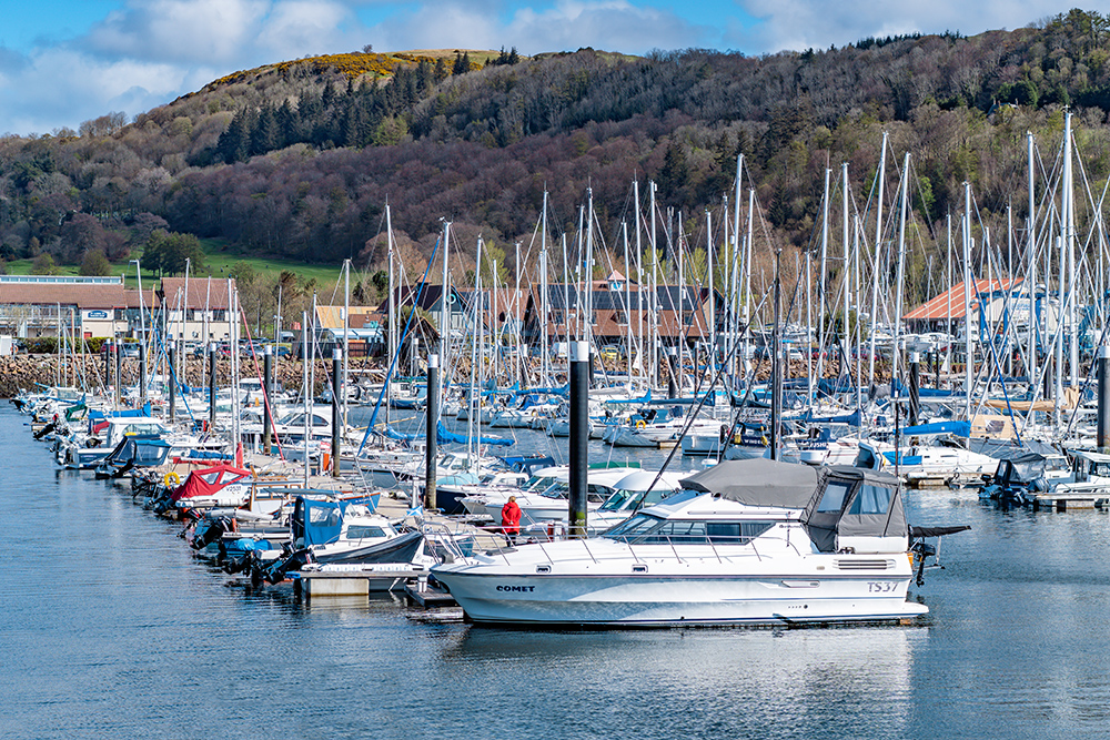Largs Yacht Haven marina with boats and hills in the background