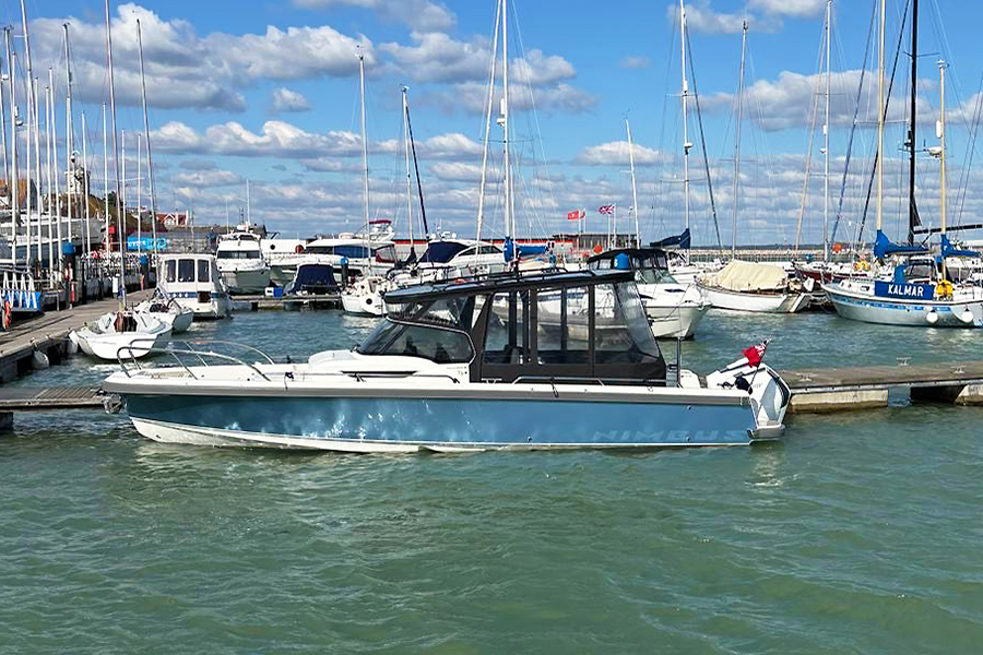 Nimbus T9 made fast to a pontoon in a marina.