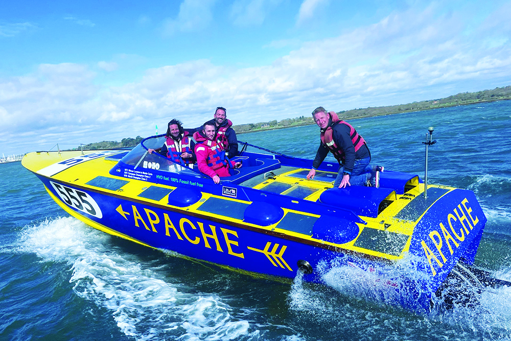 Apache 555 offshore racing powerboat underway with crew onboard, testing on coastal waters.