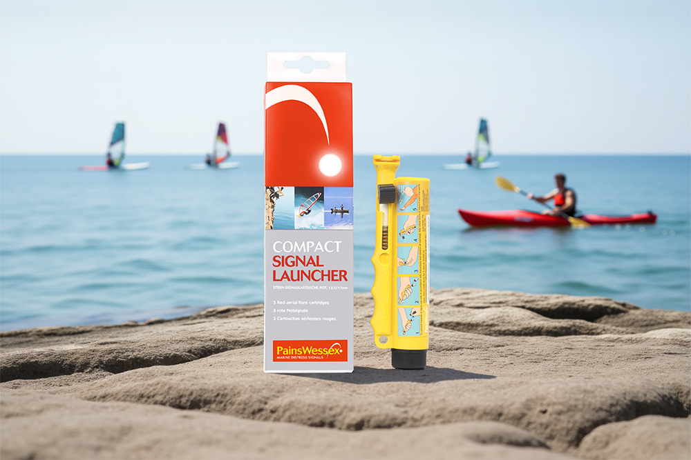 Pains Wessex compact signal launcher and Miniflare on shore with kayaker and windsurfers offshore in background.