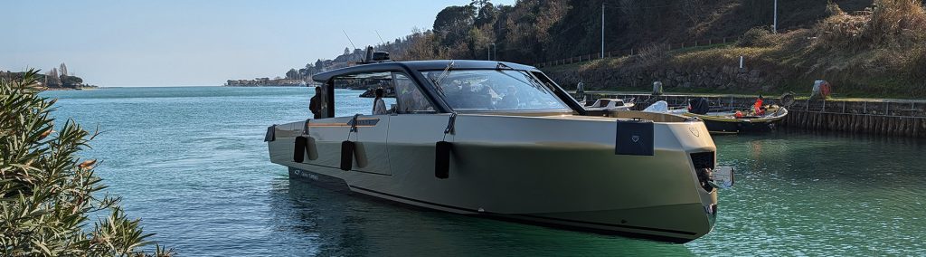 Forte 47 Gran Turismo aluminium yacht in calm coastal waters, showcasing sleek lines and enclosed helm design.