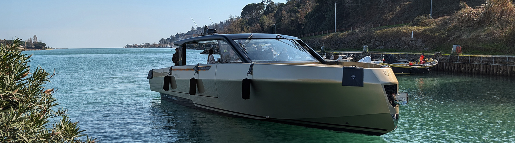 Forte 47 Gran Turismo aluminium yacht in calm coastal waters, showcasing sleek lines and enclosed helm design.