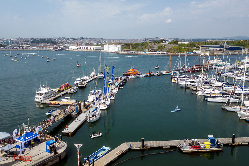 Plymouth Yacht Haven marina during Boat Fest, with pontoons, moored boats, visitors and RNLI vessels on display