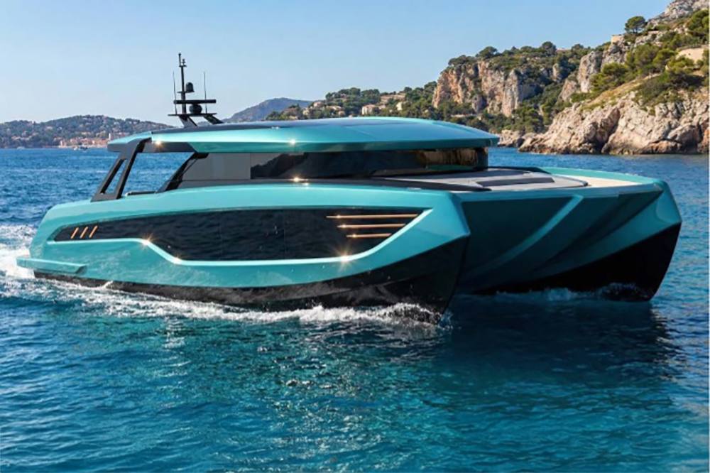 Panthera Wild 50 high-performance catamaran underway off a rocky Mediterranean coastline with futuristic styling and enclosed wheelhouse.