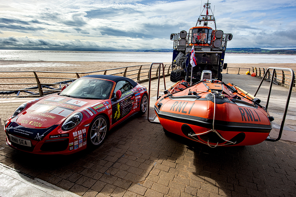 RNLI D lifeboat and fundraising Porsche 911 on Exmouth slipway during RNLI 911 Challenge naming event.