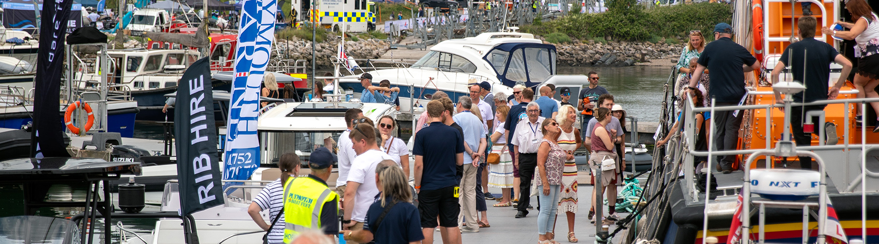 People walking along pontoons at Plymouth Boat Fest boat show