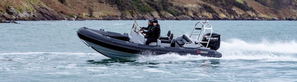 Redbay Stormforce 650 RIB underway at speed offshore, with crew aboard and Suzuki outboard in coastal waters