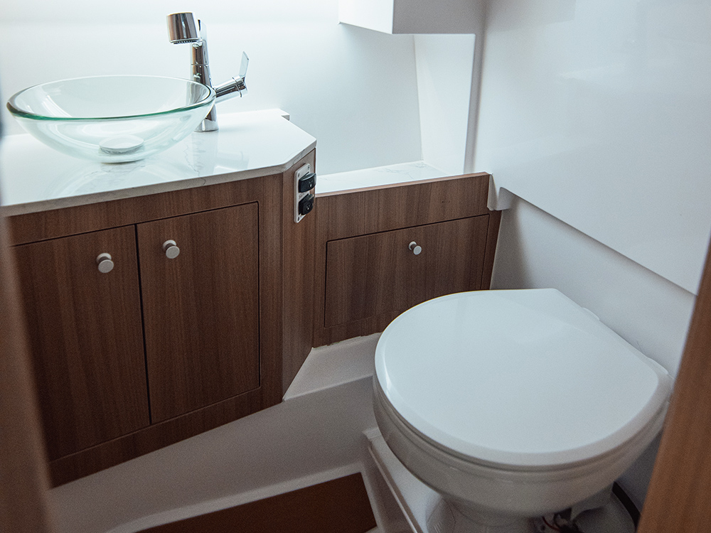 Heads compartment on Sterk 26 showing loo and basin with dim lighting