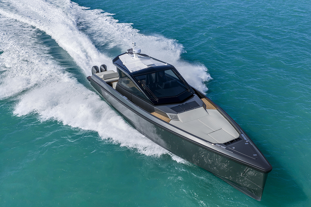 Wally wallypower50X underway at speed, showcasing its sharp bow, glazed superstructure and quad Mercury outboards in turquoise water.