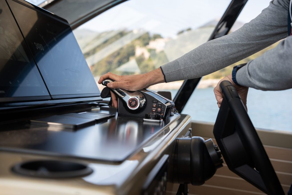 Helm control close-up on Forte 47 Gran Turismo, showing throttle, wheel and glass displays during sea trials