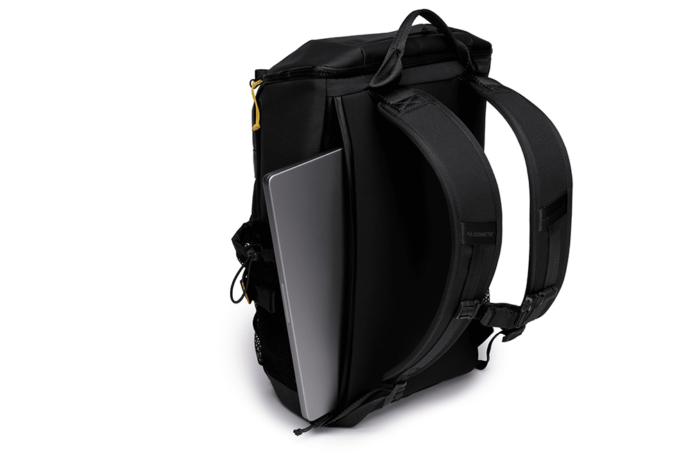 Dometic cooler backpack showing padded straps and rear laptop sleeve with device inserted for daily carry use