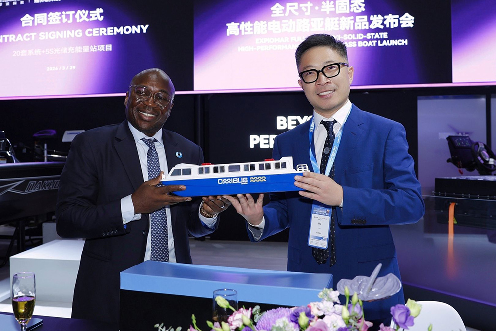 ExploMar and Caverton executives hold OMIBUS EV ferry model at CIBS electric propulsion deal signing ceremony
