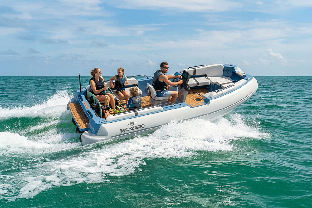Family cruising on MC-ZERO 450 electric tender at speed, showcasing spacious deck, helm layout and twin jet performance on open water