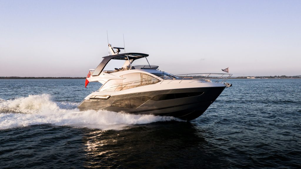 Sunseeker Manhattan 56 flybridge motor yacht underway at speed, planing across open water in calm conditions.