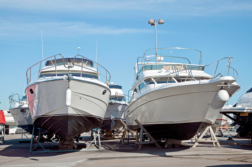 Two motorboats on wooden supports in dry winter storage