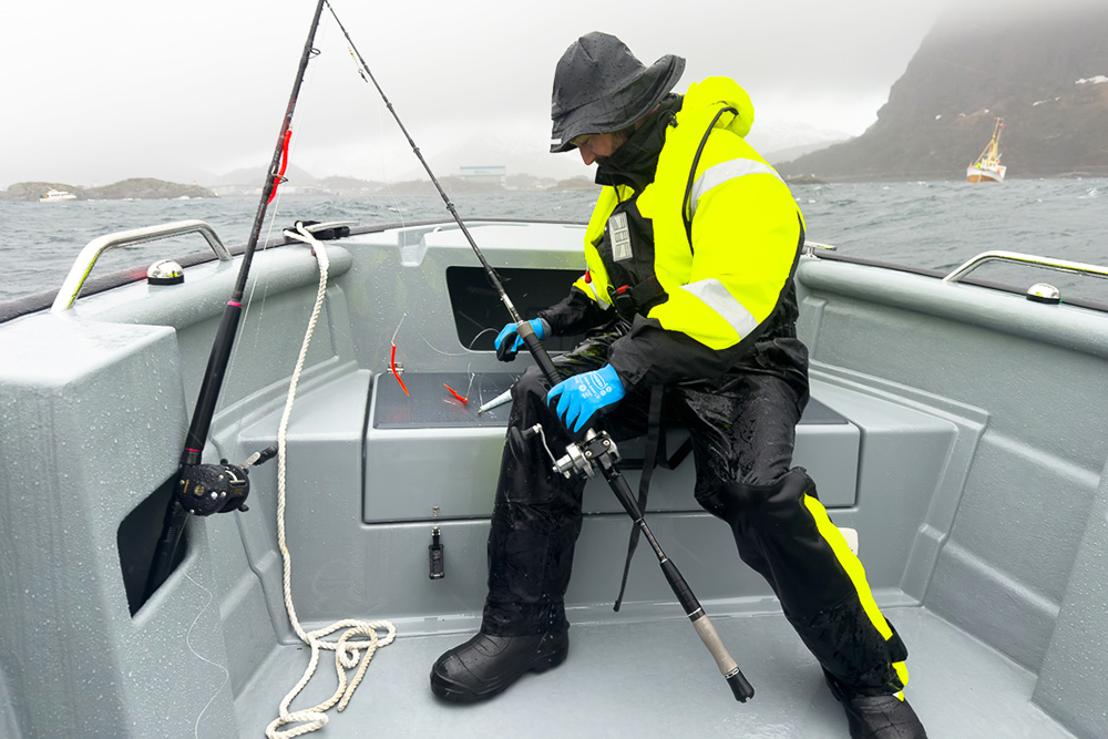 fisherman preparing fishing rod in bow of boat