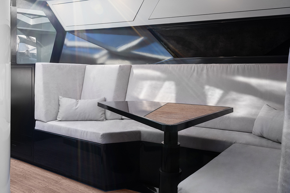 Rectangular grey upholstered seating until with dining table to centre
