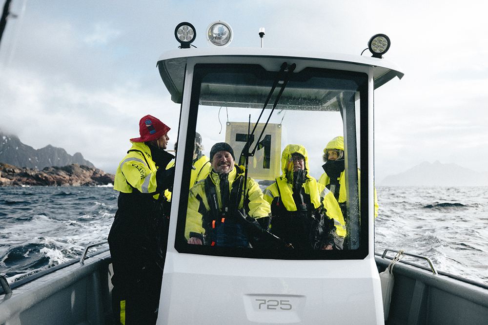 Crew aboard open T Top boat dressed in fishing clothing