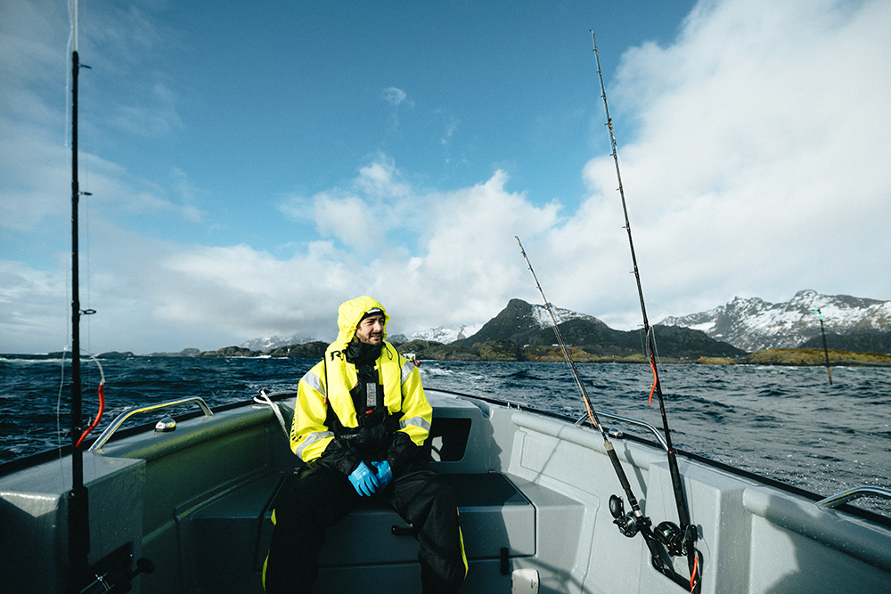 Fishermen sat in bow of Sting 725 boat looking for skrei cod fish
