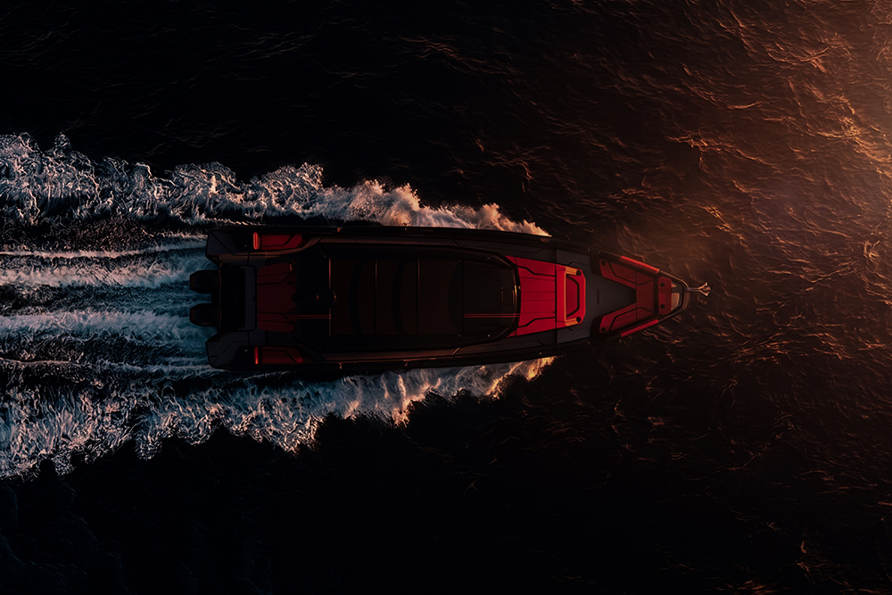 BRABUS Shadow 38 performance boat underway at sunset, viewed from above with twin outboards and illuminated deck lighting