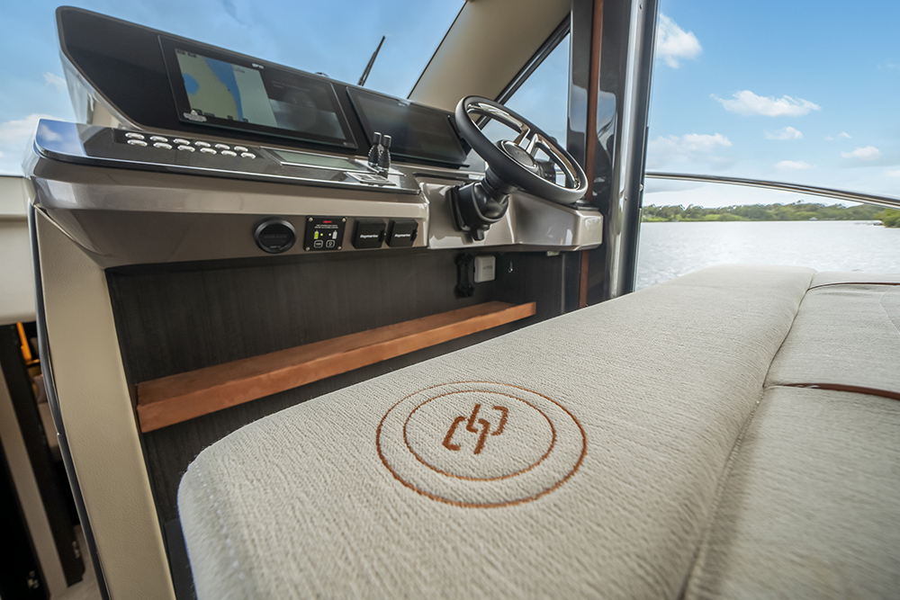 Galeon 520 FLY helm station with integrated Raymarine displays and modern flybridge yacht controls overlooking the water