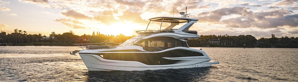 Galeon 520 FLY cruising at sunset, showcasing the yacht’s sleek flybridge profile and expansive glazing