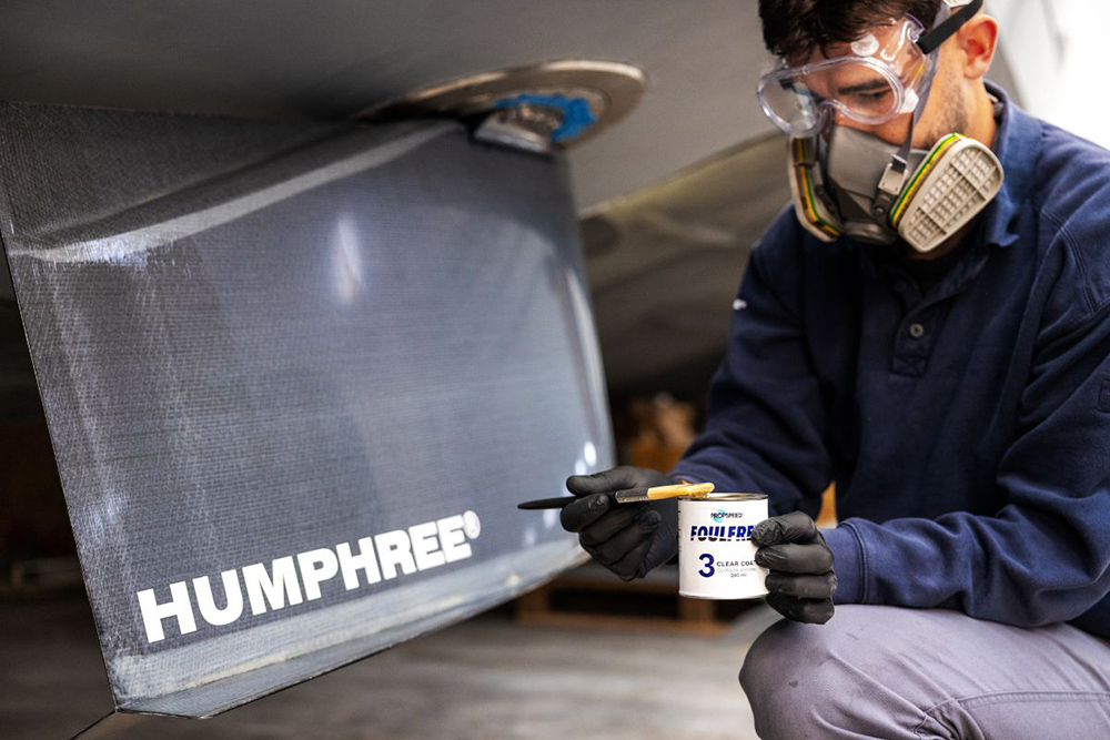 Technician applying Propspeed Foulfree coating to Humphree stabiliser fin during marine maintenance work.