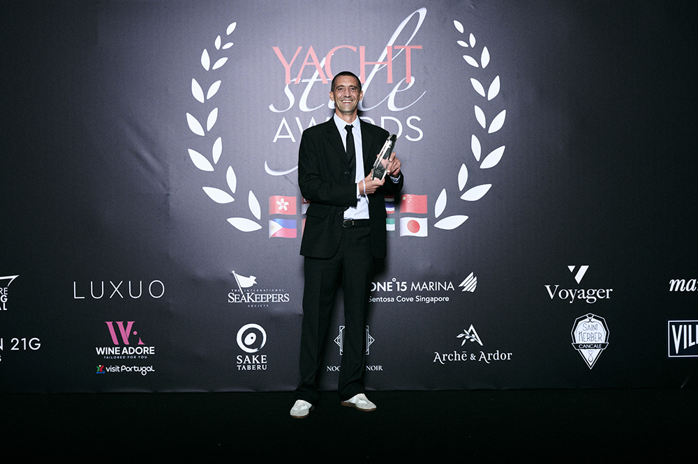 Aquila representative holding Yacht Style Awards 2026 trophy after Aquila 46 Yacht category win