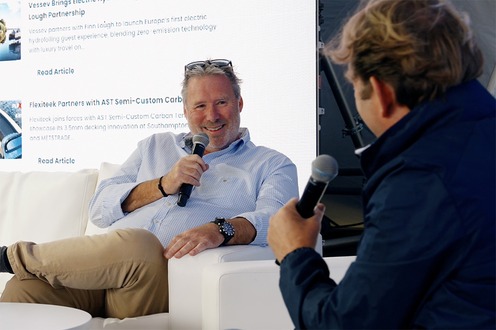 Hugo Montgomery-Swan interviewing Paul Glatzel, sat on sofas with a PBR backdropo screen behind