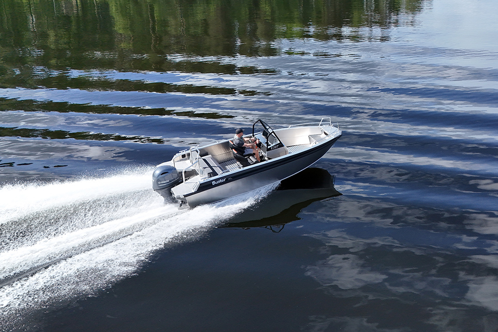 Buster XL CC aluminium centre console boat underway on calm water with Yamaha outboard