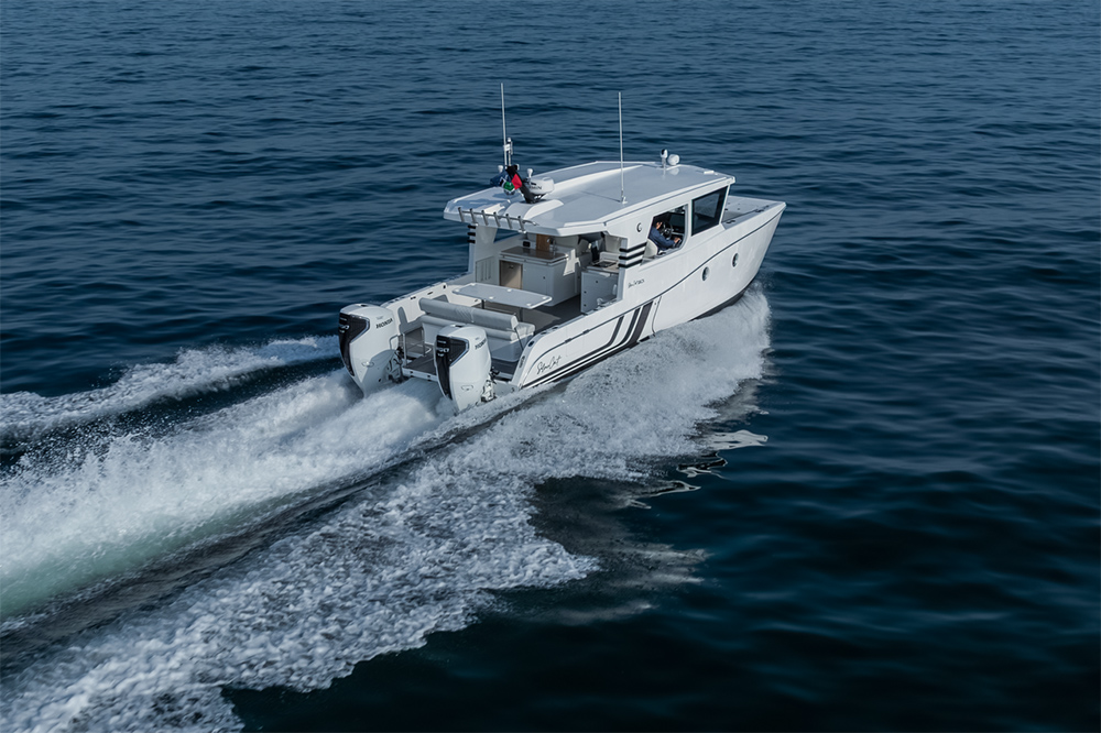 SilverCat power catamaran running offshore with twin outboards, enclosed cabin and wide aft deck visible