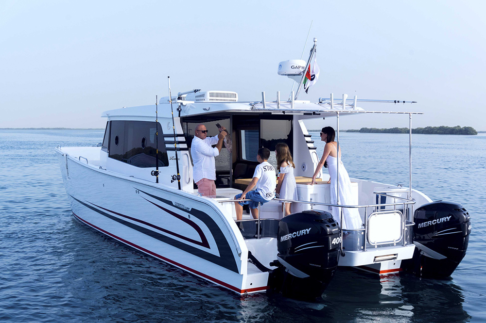 SilverCat power catamaran with family aboard, twin Mercury outboards and open aft deck on calm water
