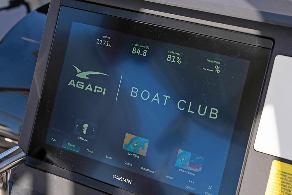 Garmin helm display showing Agapi Boat Club data, fuel level and navigation tools aboard an Axopar boat