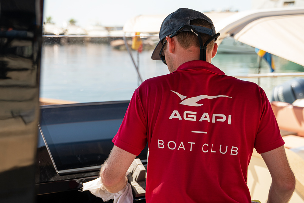 Agapi Boat Club crew member preparing an Axopar boat at a marina for shared boating use