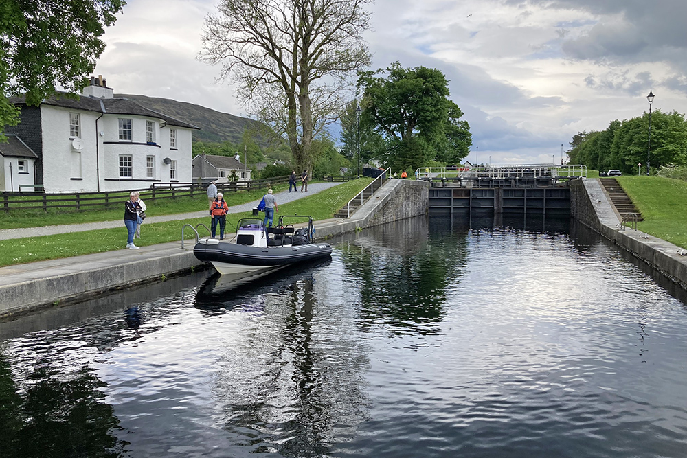 RIB moored below Neptune’s Staircase on the Caledonian Canal, with lock gates ahead