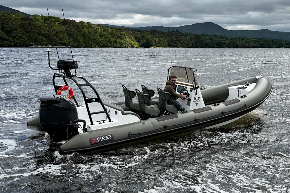 Redbay 850 RIB at rest at sea with trees in background