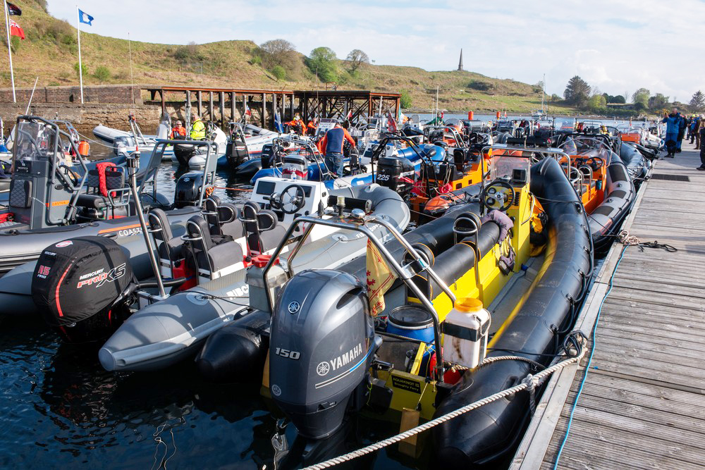 Large quantity of RIBs rafted side by side made fast to pontoons for RIB Rendezvous event