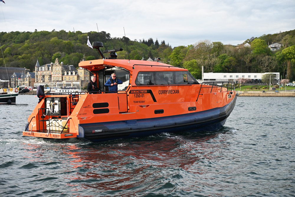Redbay cabin RIB in bright orange in a marina