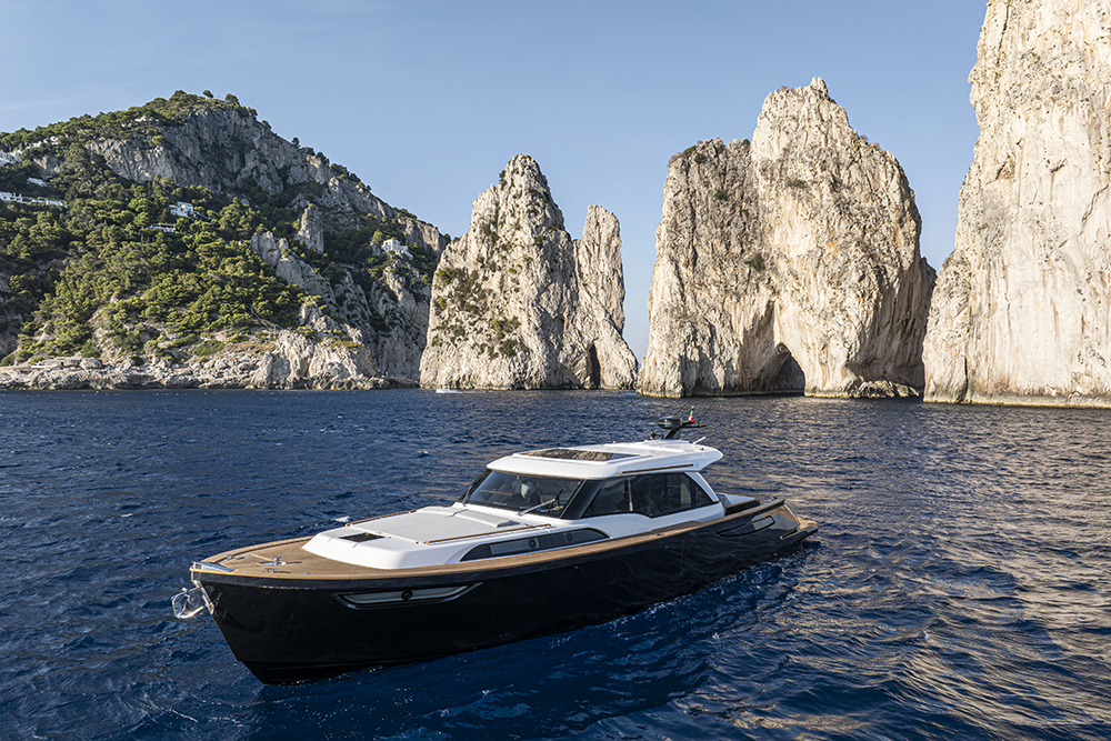 Ad Astra 60 motor yacht near Capri’s Faraglioni cliffs in clear Mediterranean waters
