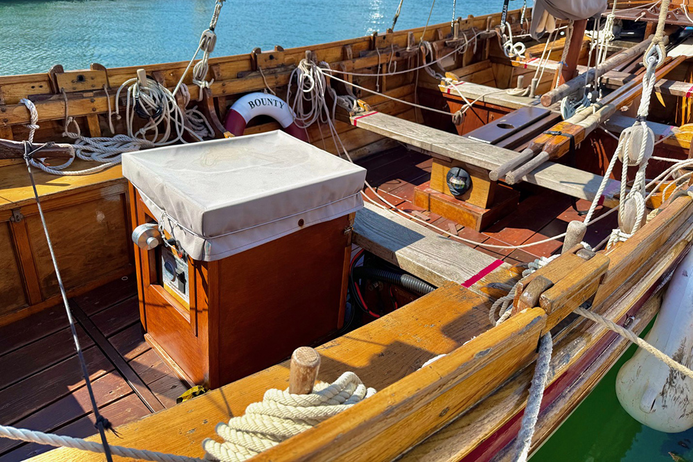 Classic wooden boat cockpit with ropes and helm detail on display at Plymouth Boat Fest.
