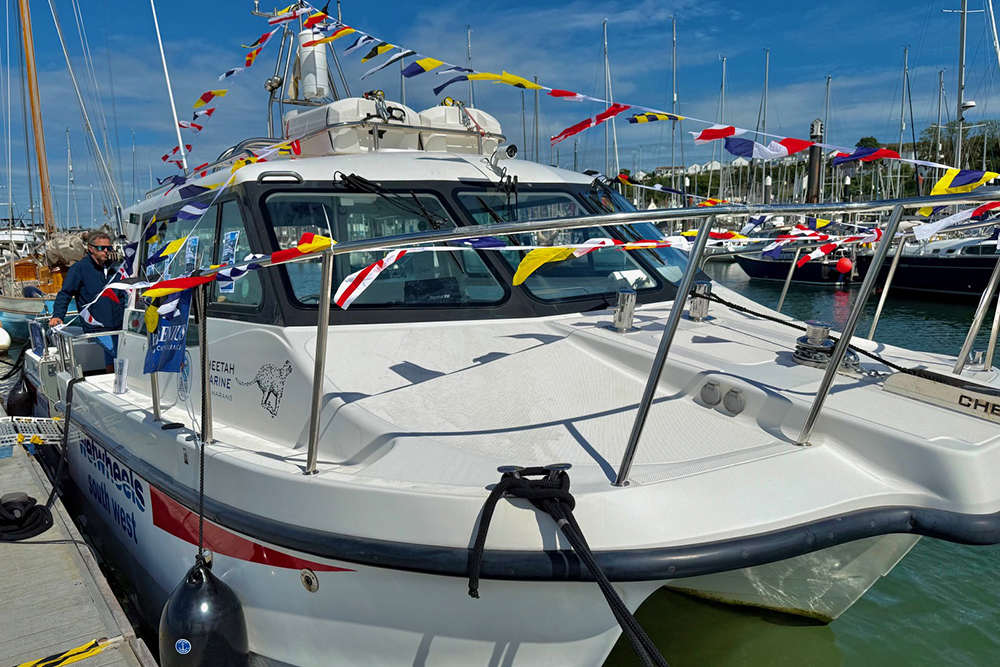 Cheetah Marine catamaran decorated with bunting on the Plymouth Boat Fest pontoons.