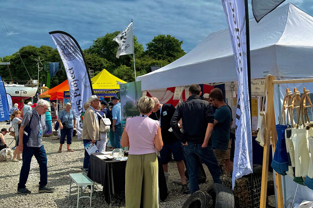 Visitors browsing marine technology and conservation stands at Plymouth Boat Fest.