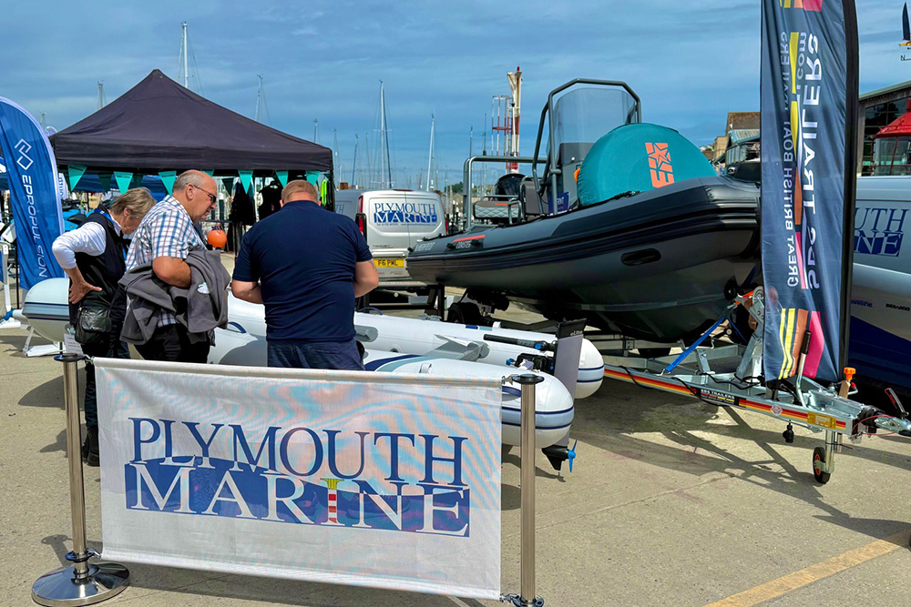 Plymouth Marine RIB display at Plymouth Boat Fest with visitors viewing boats by the marina.