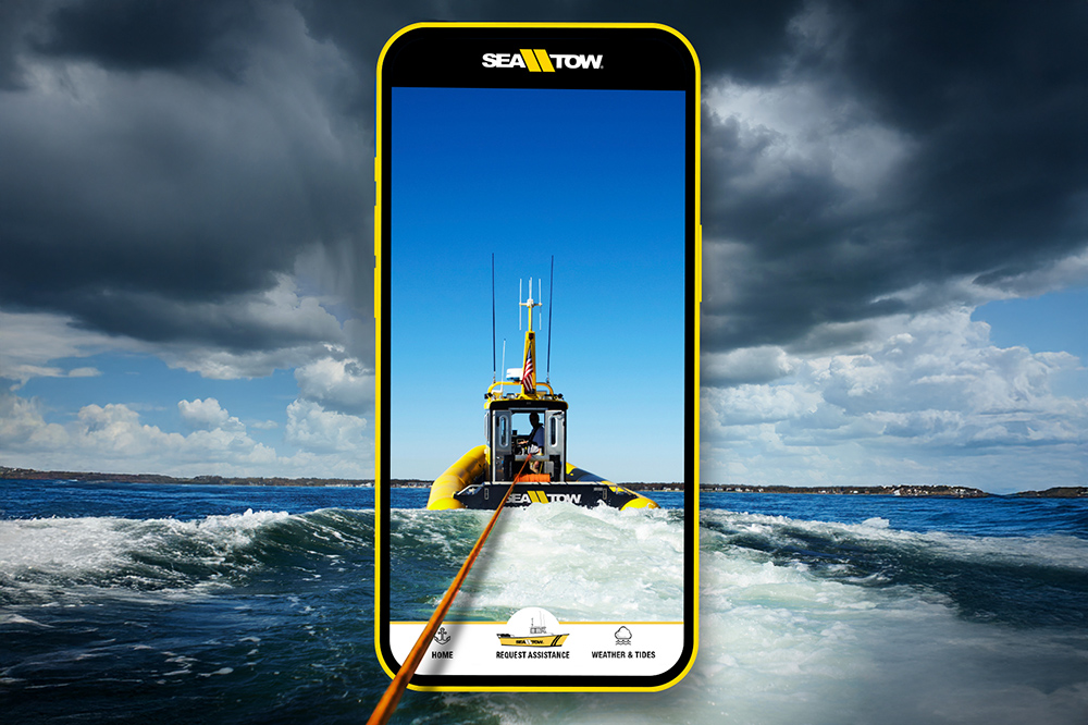 Sea Tow mobile app showing an assistance boat towing through rough seas beneath storm clouds.